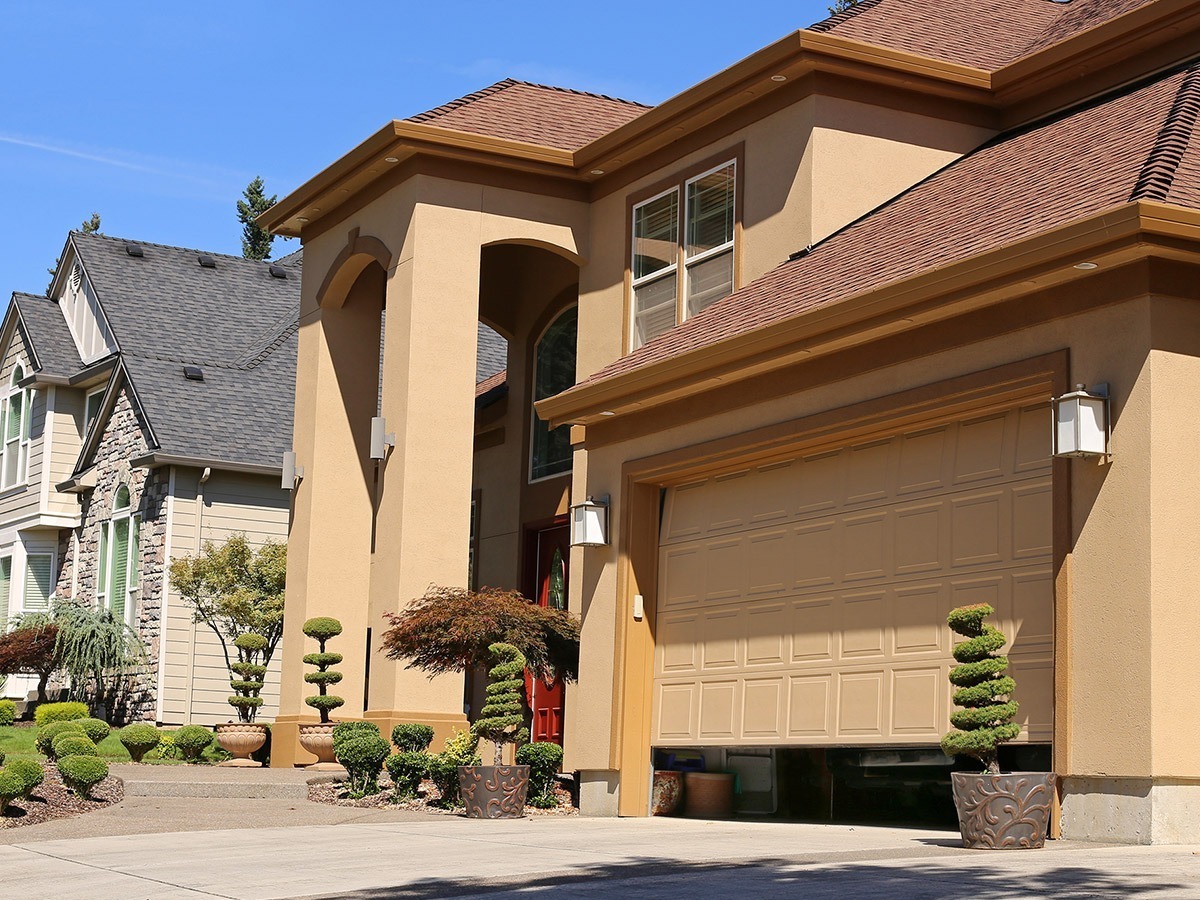 Home with garage door left open.