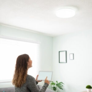 woman turning on smart lights