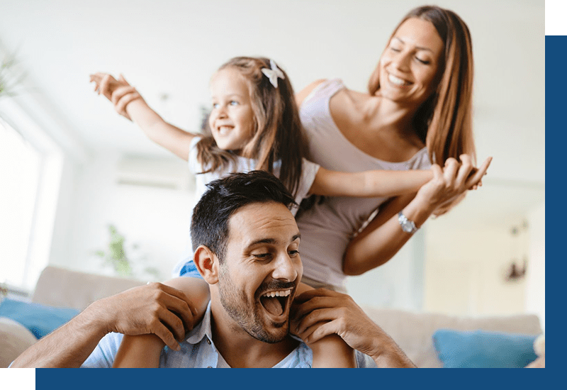 Family laughing together in house