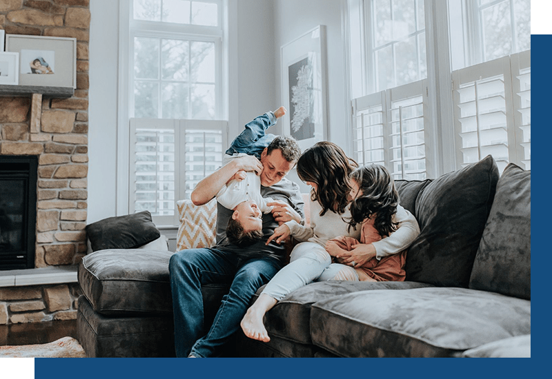 Family hanging out on the couch in home