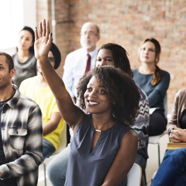 employee raising hand at training session