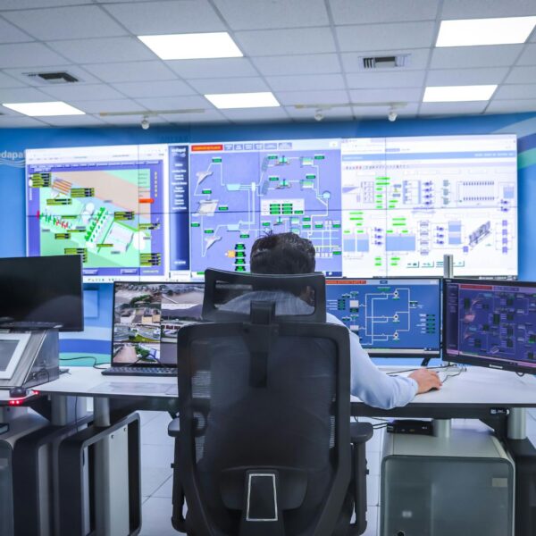A team of security monitoring professionals working at their computer stations in a command center.