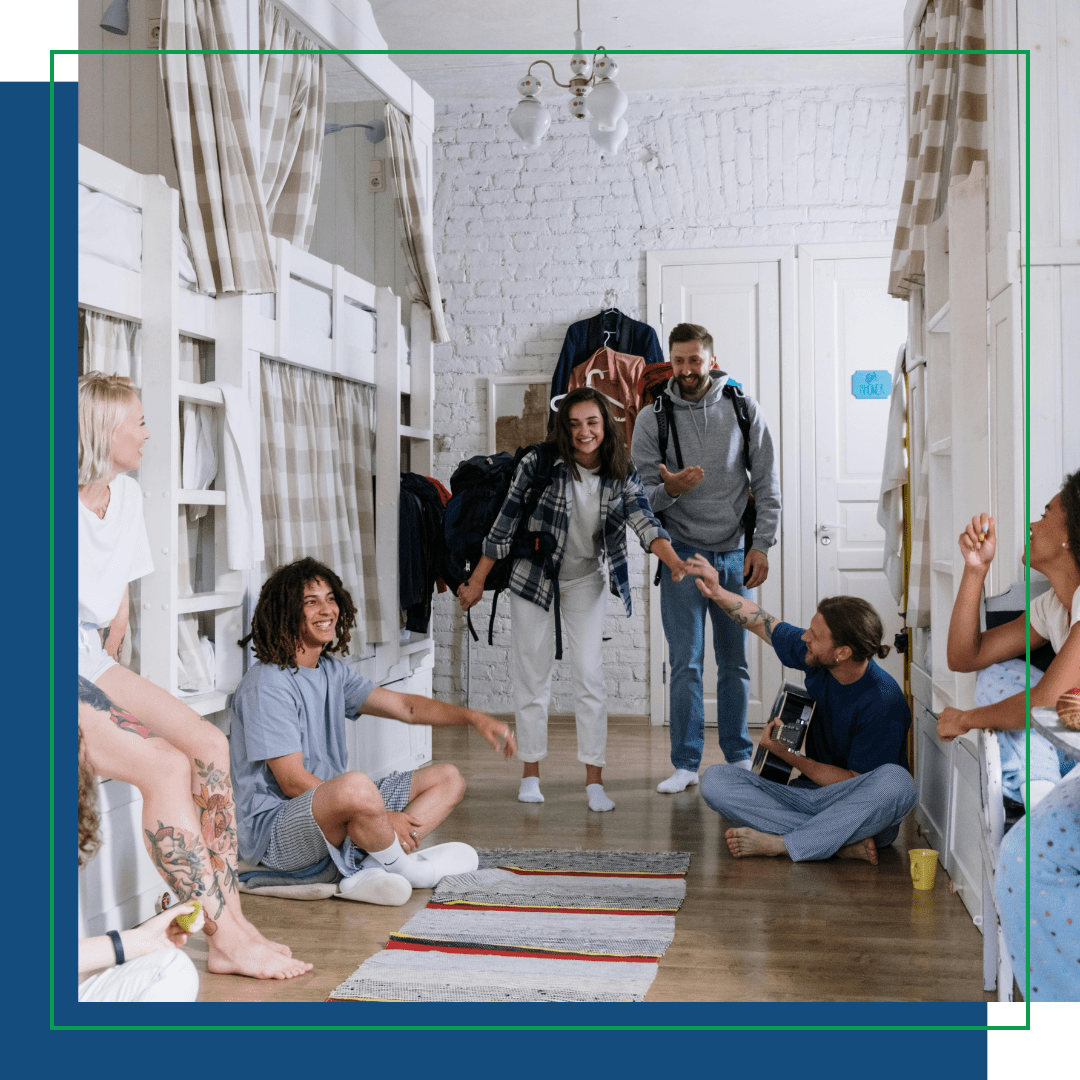 student housing with a group of students inside of one room